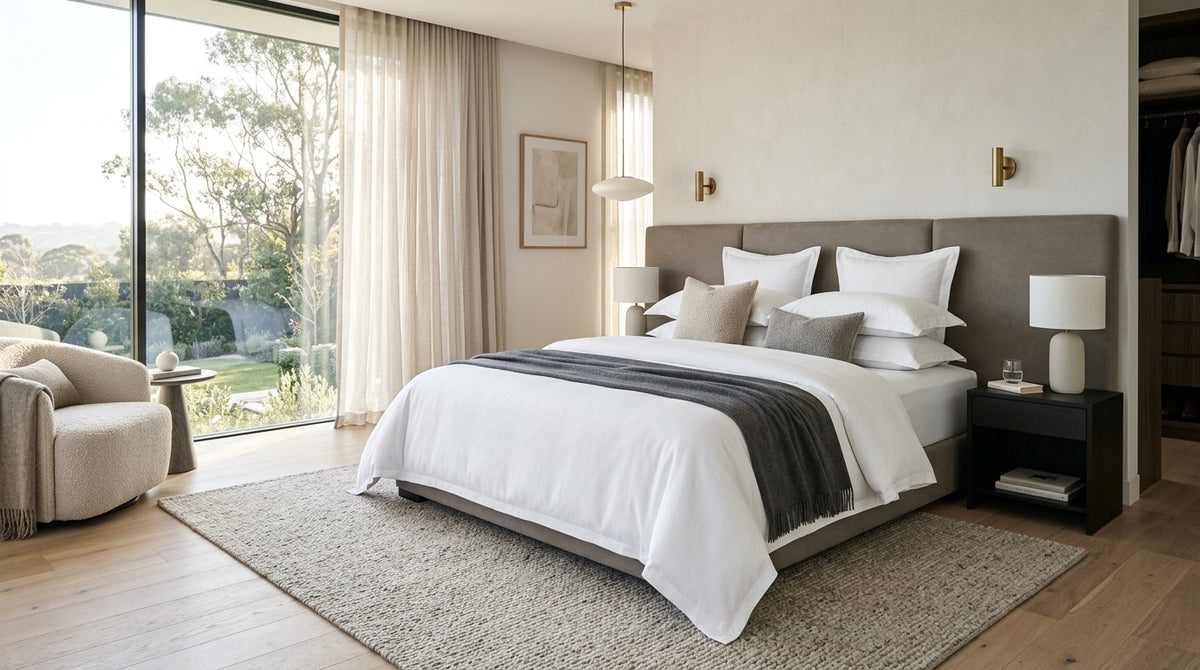 Modern luxury bedroom with perfectly made bed and hotel-tight fitted sheets tucked securely around mattress corners