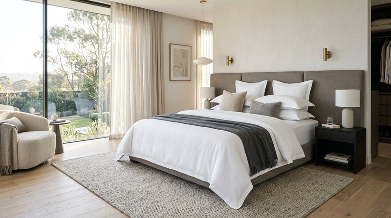 Modern luxury bedroom with perfectly made bed and hotel-tight fitted sheets tucked securely around mattress corners