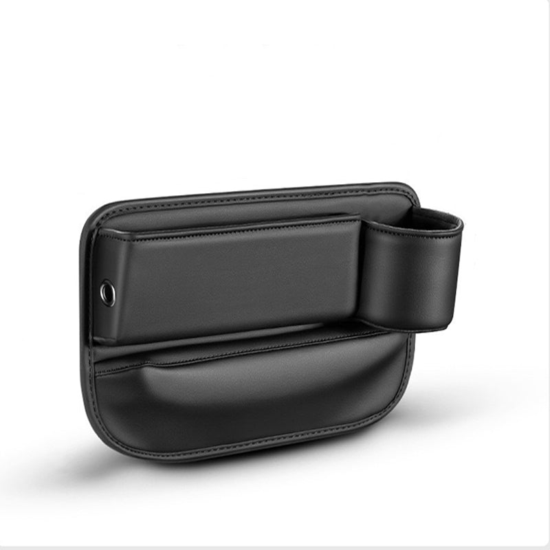 Driver-side vehicle interior view showing smartphone and sunglasses neatly stored in car seat gap