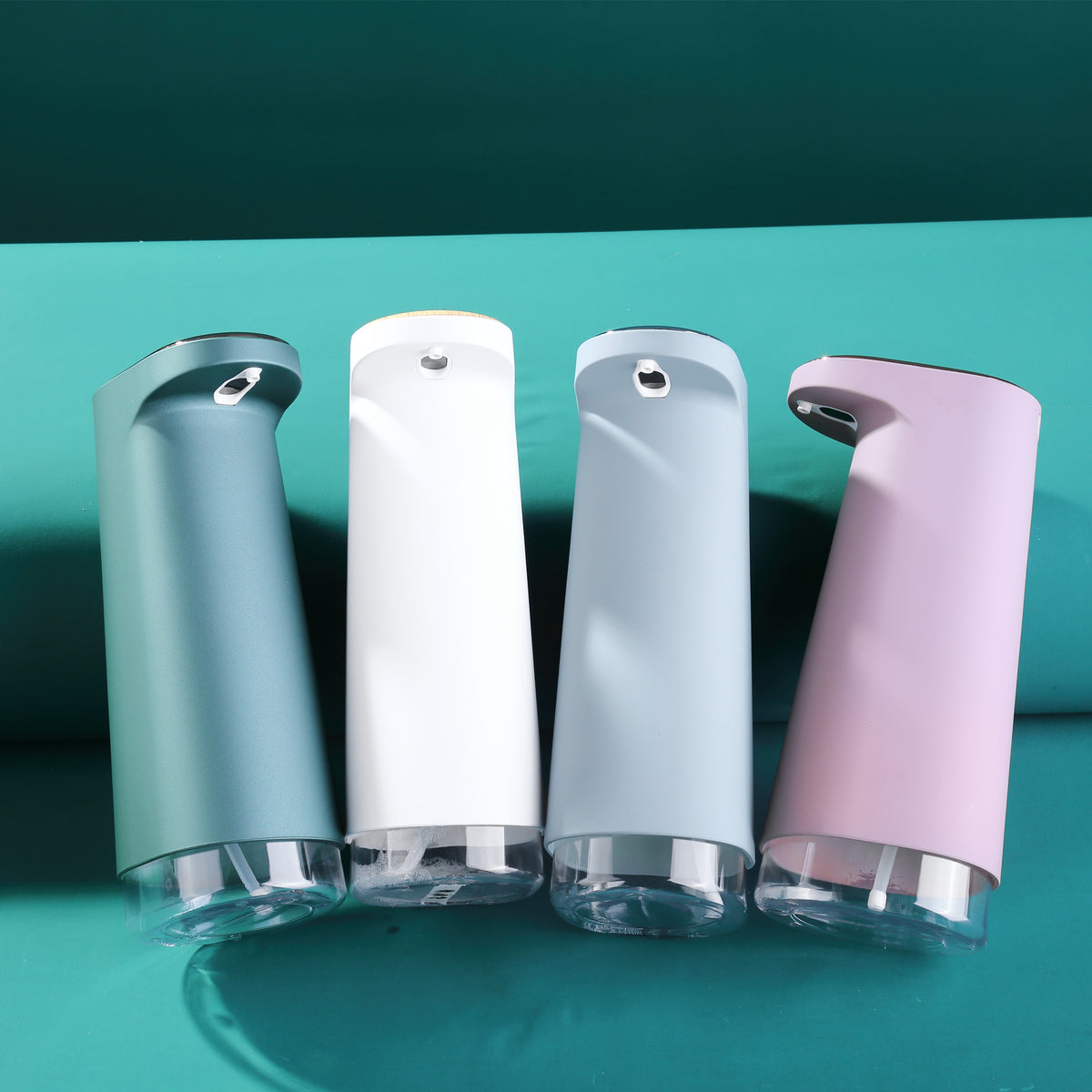 Automatic touchless foaming soap dispenser color lineup on bathroom vanity shelf