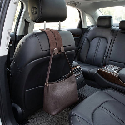 IntelWink brown suede dual headrest hook installed in luxury vehicle holding a leather handbag