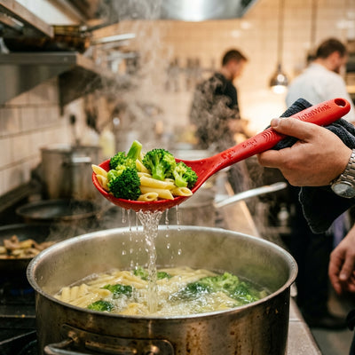 IntelWink 6-in-1 Cooking Spoon slotted strainer lifting and draining penne pasta and broccoli florets from boiling pot