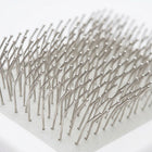 Close-up of pet slicker brush rounded stainless steel pins for gentle skin-safe grooming