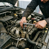 Mechanic using IntelWink 24-tooth ratchet wrench with universal socket on automotive engine bracket under car hood
